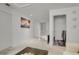 Hallway features a laundry area, beach-themed decor, and neutral carpet flooring at 12685 E 104Th Pl, Commerce City, CO 80022