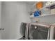 Laundry room featuring modern washer and dryer with storage shelves at 12685 E 104Th Pl, Commerce City, CO 80022