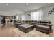Spacious living room with a large sectional sofa, hardwood floors, and open concept layout at 12685 E 104Th Pl, Commerce City, CO 80022