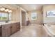 Bright bathroom featuring double sinks with granite countertops, a soaking tub and a separate shower at 17275 Gwilym Ct, Monument, CO 80132