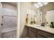 Bright bathroom featuring a tub and shower combo with marble backsplash, light countertops, and modern finishes at 17275 Gwilym Ct, Monument, CO 80132