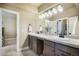 Bright bathroom featuring double sinks, modern lighting, and neutral color palette at 17275 Gwilym Ct, Monument, CO 80132