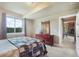 Comfortable bedroom with large window and natural light, complete with wood dresser at 17275 Gwilym Ct, Monument, CO 80132