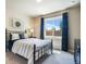 Bright bedroom with black iron bed frame, blue drapes, and serene decor at 17275 Gwilym Ct, Monument, CO 80132