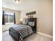 Cozy bedroom featuring a checkered bed set, a window and warm, neutral colors at 17275 Gwilym Ct, Monument, CO 80132