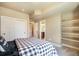 Neutral bedroom featuring an open closet and glimpses of the bathroom through the doorway at 17275 Gwilym Ct, Monument, CO 80132