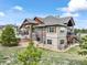 Home exterior with stone accents, a back deck and landscaping at 17275 Gwilym Ct, Monument, CO 80132