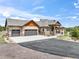 Inviting home with a three-car garage, a covered porch, and a large driveway at 17275 Gwilym Ct, Monument, CO 80132
