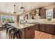 Elegant kitchen featuring stainless appliances, custom cabinets, and an island with barstool seating at 17275 Gwilym Ct, Monument, CO 80132