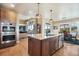 Gourmet kitchen with stainless appliances, double ovens, and a view to dining area at 17275 Gwilym Ct, Monument, CO 80132