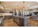 Open kitchen with a large island, stainless steel appliances, and connection to living space at 17275 Gwilym Ct, Monument, CO 80132