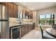 Kitchenette in finished basement features a stainless steel refrigerator, cabinets, counter and a view to the backyard at 17275 Gwilym Ct, Monument, CO 80132