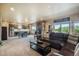 Open-concept living area with modern fireplace, bar, and comfortable seating area at 17275 Gwilym Ct, Monument, CO 80132