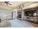 Spacious living room featuring a stone fireplace and custom built-ins for entertainment at 17275 Gwilym Ct, Monument, CO 80132