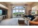 Relaxing living room boasts a sectional sofa, large TV, sliding glass doors leading to an outdoor patio, and an open layout at 17275 Gwilym Ct, Monument, CO 80132