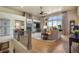 Open-concept living room with large windows, fireplace, and hardwood floors. Beautiful natural light at 17275 Gwilym Ct, Monument, CO 80132