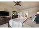 Spacious main bedroom with neutral tones, a ceiling fan and two dressers plus an adjoining bathroom at 17275 Gwilym Ct, Monument, CO 80132