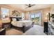 Serene main bedroom with a private balcony, large windows, and a ceiling fan at 17275 Gwilym Ct, Monument, CO 80132