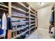 Custom walk-in closet with built-in shelves and racks, perfect for organizing clothes and shoes at 17275 Gwilym Ct, Monument, CO 80132