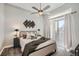 Spacious bedroom with a queen bed, dark flooring, and access to a balcony at 277 N Broadway # 208, Denver, CO 80203