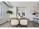 Elegant dining area with a wooden table and white chairs at 277 N Broadway # 208, Denver, CO 80203