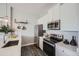 Well-equipped kitchen featuring white cabinets and stainless steel appliances at 277 N Broadway # 208, Denver, CO 80203