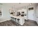 Modern kitchen with white cabinets, stainless steel appliances, and a breakfast bar at 277 N Broadway # 208, Denver, CO 80203