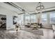 Open living space with hardwood floors, large windows, and a view into the bedroom at 277 N Broadway # 208, Denver, CO 80203