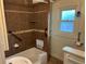 Bathroom with tile accents, a shower-tub combination, and accessible features at 437 6Th St, Frederick, CO 80530