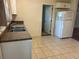Bright kitchen features white cabinets, modern appliances, and tile flooring at 437 6Th St, Frederick, CO 80530