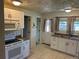 Bright kitchen features white cabinets, modern appliances, and a convenient sink with a window at 437 6Th St, Frederick, CO 80530