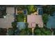 Aerial view of a large property with a main house, swimming pool, basketball court, and a lush green yard at 235 Eudora St, Denver, CO 80220