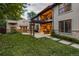 Wide backyard with a pergola, stone patio with furniture, and a built-in outdoor kitchen at 235 Eudora St, Denver, CO 80220