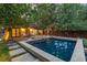 Inviting backyard features a refreshing pool, lounge chairs and a cozy fire pit surrounded by lush greenery at 235 Eudora St, Denver, CO 80220