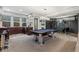Basement features a pool table, bar area, and elegant lighting for entertaining guests at 235 Eudora St, Denver, CO 80220