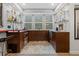 Basement bar boasts stylish cabinetry, shelving, stone tile and modern appliances at 235 Eudora St, Denver, CO 80220
