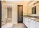 Bathroom with a granite countertop sink, an enclosed glass shower, and neutral wall color at 235 Eudora St, Denver, CO 80220