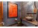 Unique powder room with ornate sink, dark wallpaper, and framed art at 235 Eudora St, Denver, CO 80220