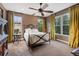Serene bedroom with an iron bed, plush carpeting, and great natural light at 235 Eudora St, Denver, CO 80220