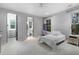 Carpeted bedroom with an attached bathroom, a walk-in closet, and a window with green views at 235 Eudora St, Denver, CO 80220