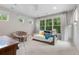 Bright bedroom with a daybed with many windows providing natural light and plush carpet at 235 Eudora St, Denver, CO 80220