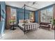 Serene bedroom showcases natural light, a four-poster bed and soft, neutral tones for relaxation at 235 Eudora St, Denver, CO 80220
