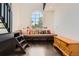 Cozy bonus room with window seat, colorful pillows, and a beautiful arched window at 235 Eudora St, Denver, CO 80220