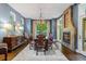 This dining room features a fireplace, chandelier, large window and hardwood flooring at 235 Eudora St, Denver, CO 80220