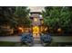 Elegant home featuring a landscaped front yard, gated entry, and well-lit facade at 235 Eudora St, Denver, CO 80220