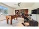 Game room featuring a foosball table, a gaming chair, and custom shelving for storage at 235 Eudora St, Denver, CO 80220