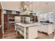 Spacious kitchen featuring stainless steel appliances, large island, and custom cabinetry at 235 Eudora St, Denver, CO 80220