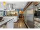Modern kitchen featuring stainless steel appliances, custom cabinets, and a sleek hardwood floor at 235 Eudora St, Denver, CO 80220