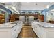 Gourmet kitchen boasts dual islands, stainless appliances, ample prep space and sleek hardwood flooring at 235 Eudora St, Denver, CO 80220