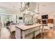 Bright and airy kitchen featuring a large island, farm sink, and pendant lighting at 235 Eudora St, Denver, CO 80220